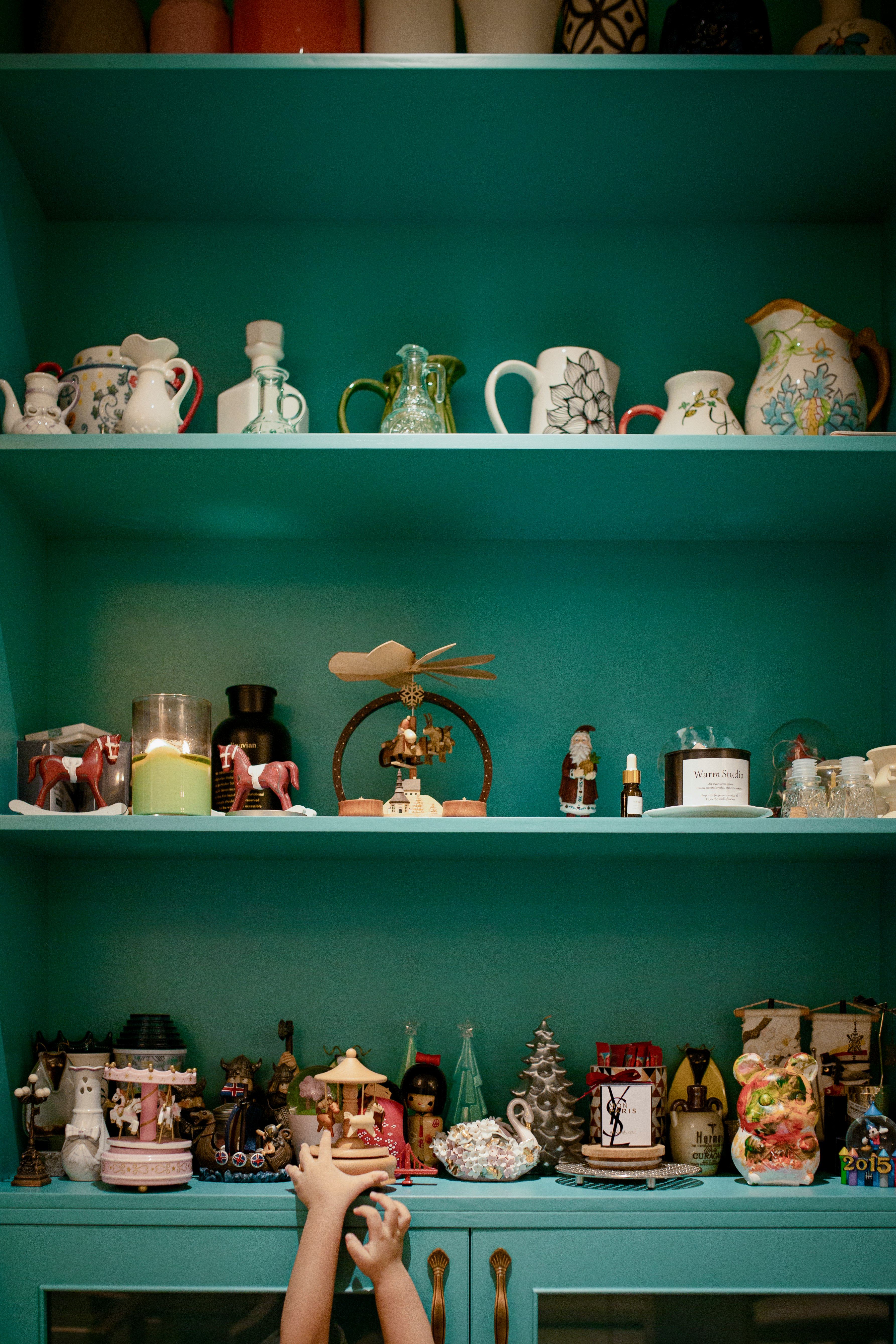 white ceramic tea set on green wooden shelf